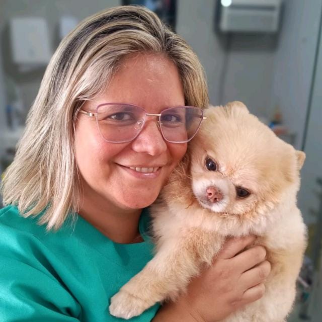 Dra. Quesia Klaus com um lulu da pomerânia após o atendimento